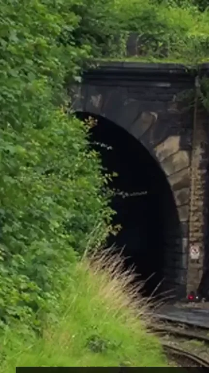 Steam rolling out of a railway tunnel, from our London Underground faceless video